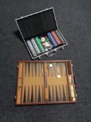 A cased backgammon set and a case of poker chips
