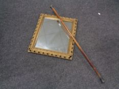 An antique gilt framed composition mirror together with a silver topped walking stick