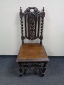 A carved oak barley twist hall chair