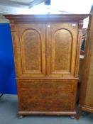 An antique walnut cocktail cabinet
