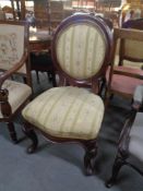 An antique mahogany balloon back chair