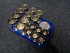 A tray of assorted plated wine glasses and coasters