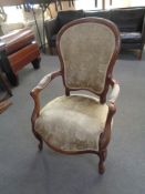 A walnut framed salon armchair in floral brocade