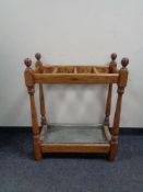 An early twentieth century oak stick stand