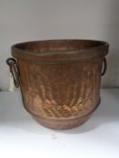 An antique copper twin handled cooking pot