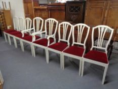 A set of eight painted dining chairs