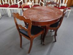 An oval dining table on cabriole legs and four antique chairs