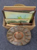 A box of assorted pictures and a embossed brass and copper wall plaque