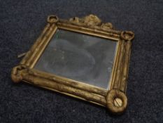 An antique gilt composite wall mirror