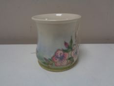 A Moorcroft spring blossom mug, height 8.5 cm.