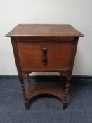 An oak work cabinet on barley twist legs