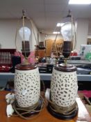 A pair of cream pottery table lamps on wooden bases
