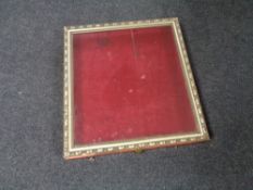 A gilt framed counter topped display cabinet with red velvet lining