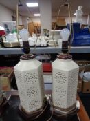 A pair of cream hexagonal pottery table lamps on wooden bases