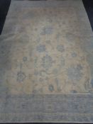 A blue floral carpet on cream ground