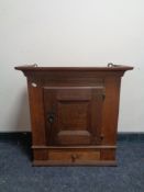 An antique oak wall cabinet fitted a drawer
