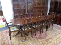 A Regency style twin pedestal extending dining table with two leaves and ten dining chairs