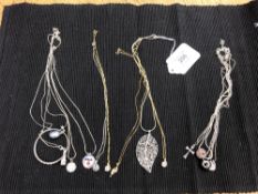 Approximately thirteen silver pendants