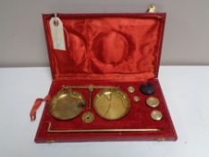 A set of vintage brass balance scales in fitted case