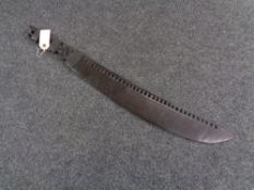 A carved tribal wooden machete