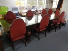 An early 20th century dining table with eight high back chairs
