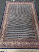 A Persian woolen rug on blue ground