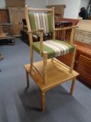 A blonde oak armchair and a lamp table