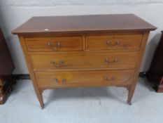 An Edwardian inlaid mahogany four drawer chest