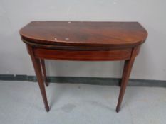 A George III inlaid mahogany turnover top table