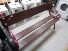 A cast iron wooden slatted garden bench