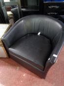 A pair of black vinyl stitched tub chairs