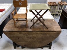 An antique oak gate leg table,