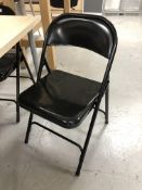 Five folding metal chairs