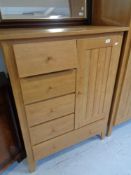 A beech effect double door wardrobe and linen cabinet