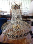 An impressive crystal drop gilt metal chandelier