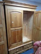A pine double door wardrobe with two drawers