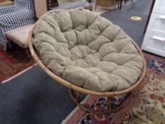 A bamboo lounge chair with cushions