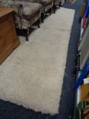 A large piece of shaggy pile carpet in cream