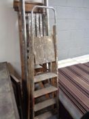 Three wooden step ladders