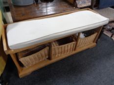 A pine storage seat fitted with wicker baskets