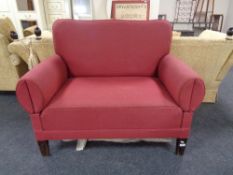 An Edwardian two seater settee in red fabric