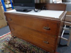 An Edwardian oak two drawer chest
