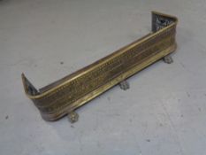 A Victorian brass fire fender