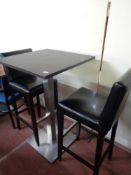 A single poser bar table together with a pair of black leather bar stools (3)