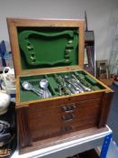 An Edwardian oak canteen of part cutlery