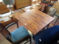 A cafe table together with a pair of chairs