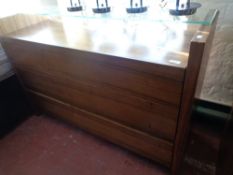 A three drawer contemporary chest with glass shelf