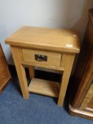 A light oak single drawer table