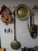 A brass bed warming pan and an embossed brass bowl