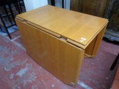 A light oak flap sided table